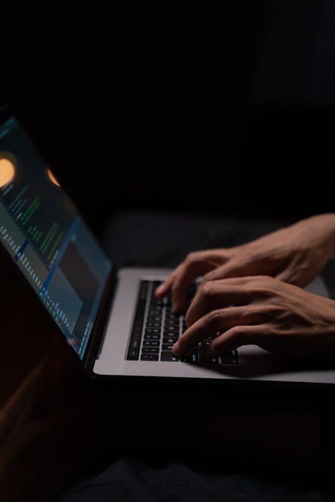 pexels photo 5496464 Hands typing code on a laptop keyboard in a dark room, capturing the essence of late-night programming.
